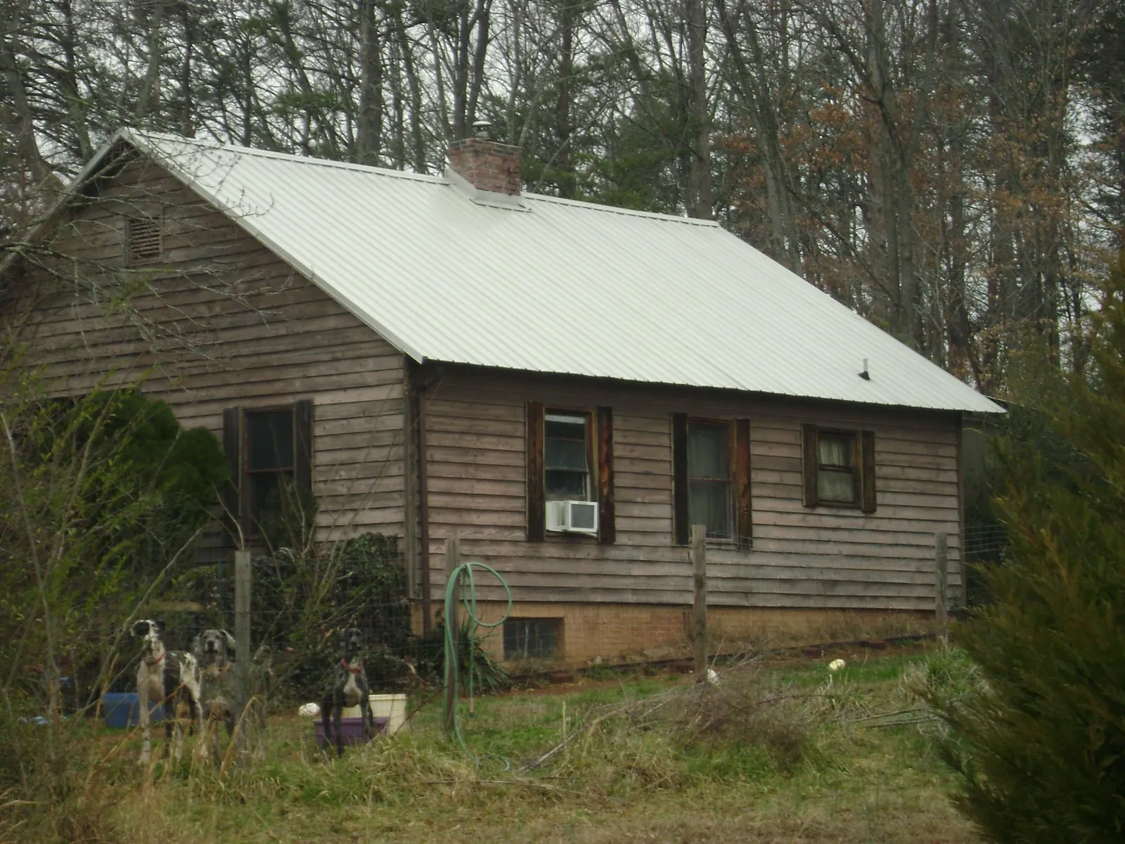 White metal roof on an old wood sided farmhouse, from a Metal Roof Installation job in Fairview